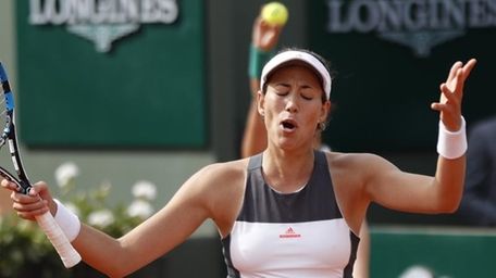 Defending champion Spain's Garbine Muguruza reacts as she