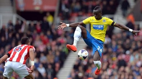 Newcastle United's Ivorian midfielder Cheick Tiote jumps for