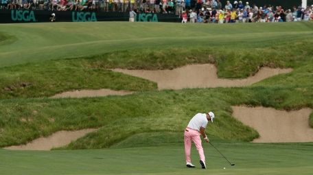 Justin Thomas hits to the 18th green during