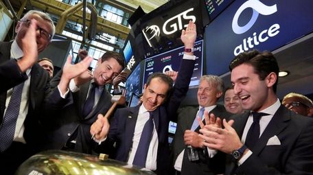 Altice founder Patrick Drahi rings the bell to