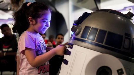 A replica of R2-D2 gets the attention of