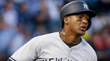 The Yankees' Miguel Andujar runs to first base