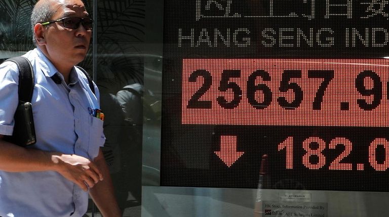 A man walks past an electronic board showing