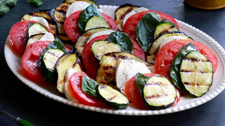 Grilled eggplant and zucchini layered with sliced tomato,