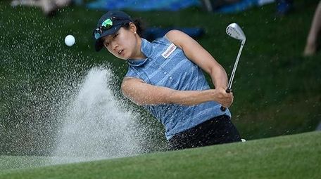 Kelly Shon chips out of a sand trap