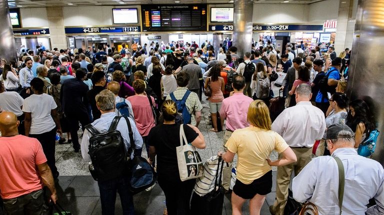 Passengers near the LIRR departures board in Penn