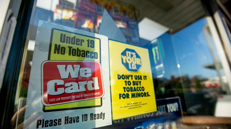 A sign noting the age for buying tobacco
