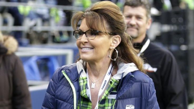Sarah Palin walks on the sideline before an