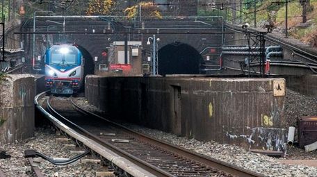 An Amtrak locomotive emerges from the North River
