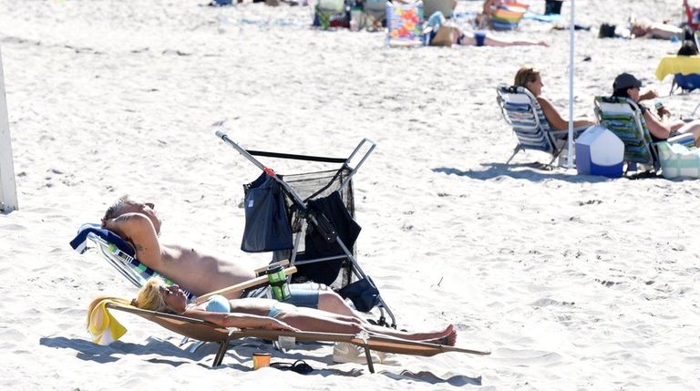 Sunbathers at Smithpoint County Beach on Sunday, July