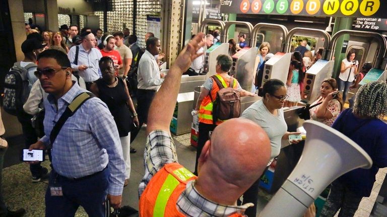 MTA personnel direct Long Island Rail Road commuters