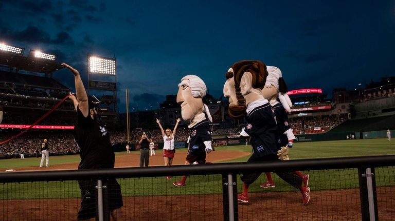 Mascots dressed as former presidents race during the