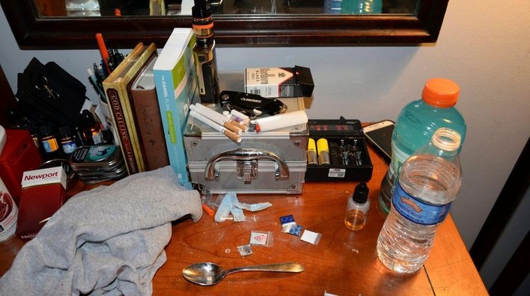 Opioid drug packets, a syringe and other belongings