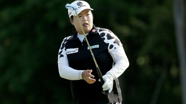 Shanshan Feng of China watches her shot on