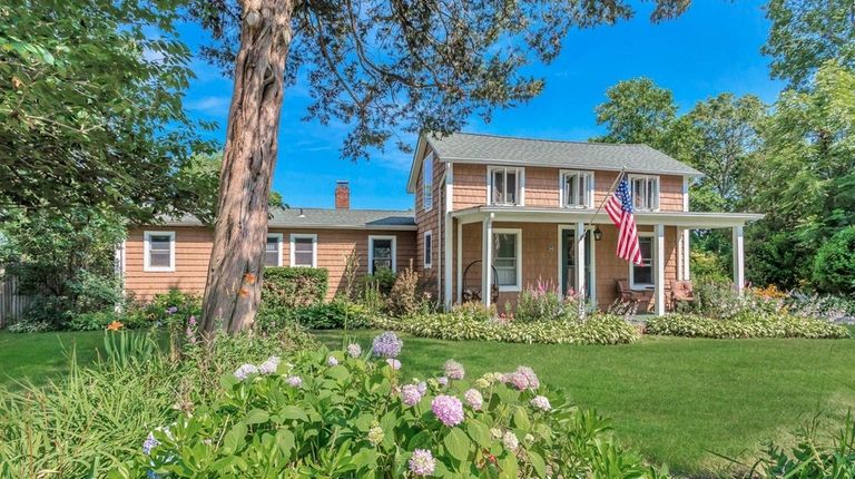 This Great River home's gardens back onto a