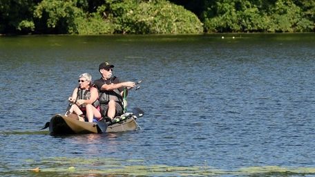 A couple enjoys fishing on a kayak on