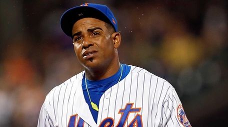 Mets' Yoenis Cespedes reacts walking to the dugout