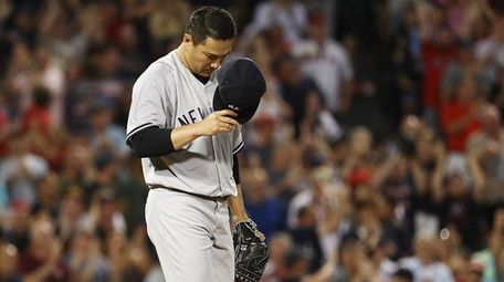 Masahiro Tanaka of the Yankees reacts after giving