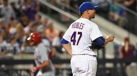 Mets pitcher Hansel Robles stands on the mound after