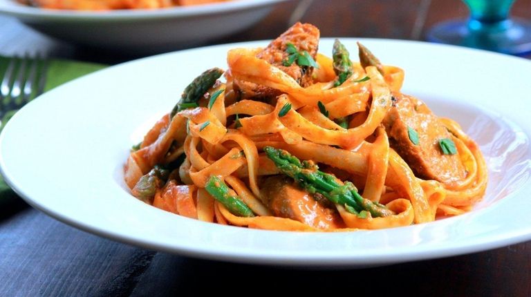 Pasta, turkey sausage and asparagus are dressed with