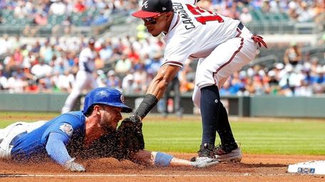 Cubs' Kris Bryant is tagged out while trying to
