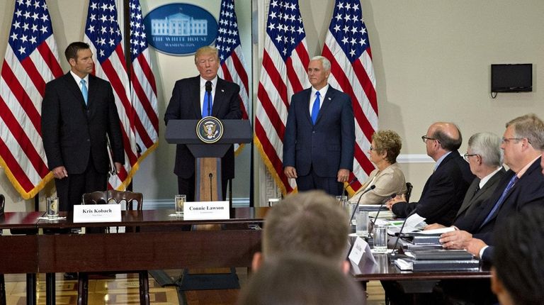 U.S. President Donald Trump, center, speaks as Vice