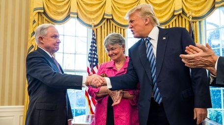 Jeff Sessions accepts congratulations from President Donald Trump
