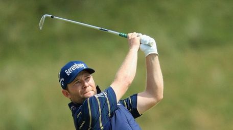 Branden Grace of South Africa hits an approach