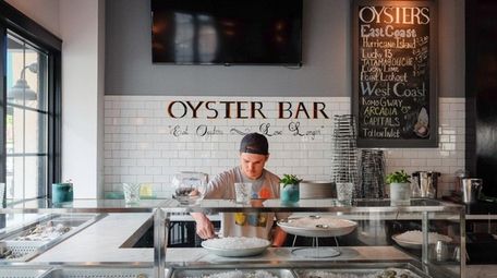 Peter Wills shucks oysters at the oyster bar