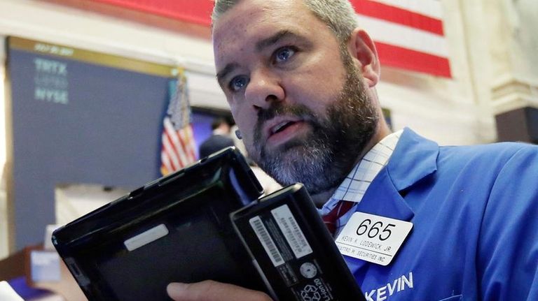 Traders Thomas Ferrigno, left, and Kevin Lodewick work