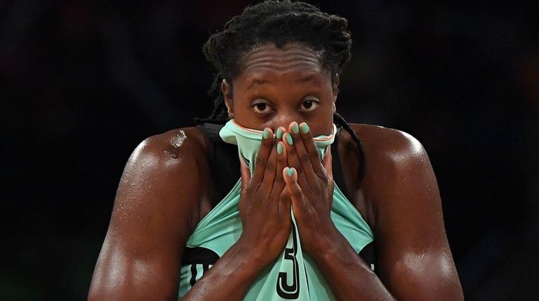 Liberty center Tina Charles wipes her face with