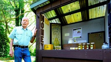 Richard Blohm, a master beekeeper in Huntington, stands