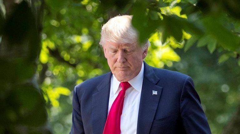 President Donald Trump walks back to the Oval
