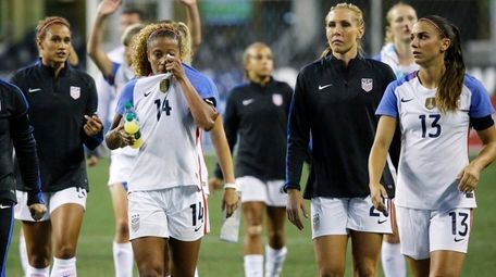 U.S. players walk off the pitch after losing
