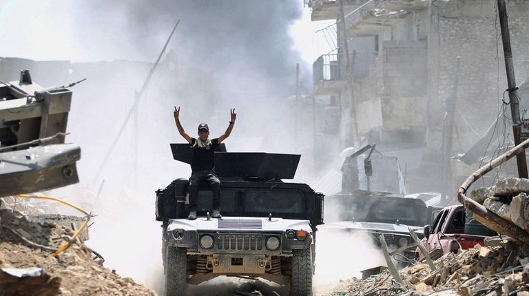 A member of the Counter-Terrorism Service raises the