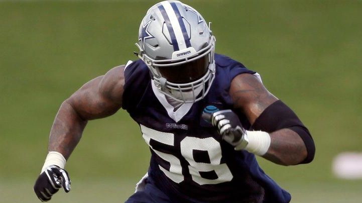 Damontre' Moore rushes against Tyron Smith, center rear,