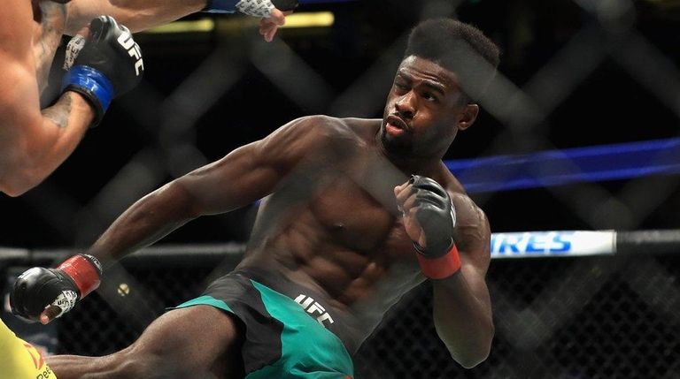 Aljamain Sterling (green shorts) fights Renan Barao of