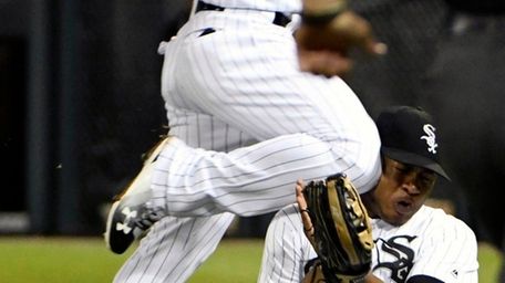 Chicago White Sox second baseman Yoan Moncada, top,