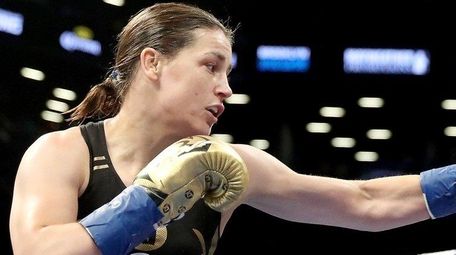 Katie Taylor corners Jasmine Clarkson during their lightweight