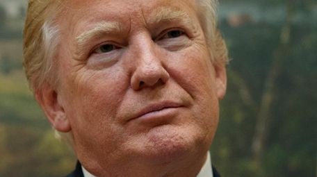 President Donald Trump listens to a presentation in