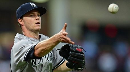 Yankees pitcher Sonny Gray tosses the ball to