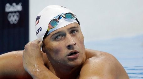 United States' Ryan Lochte checks his time in