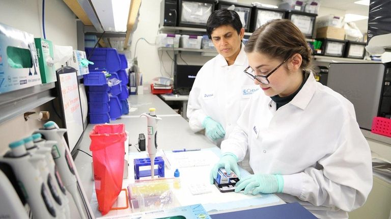 Junior scientist Melissa Ahrens, right, and research and