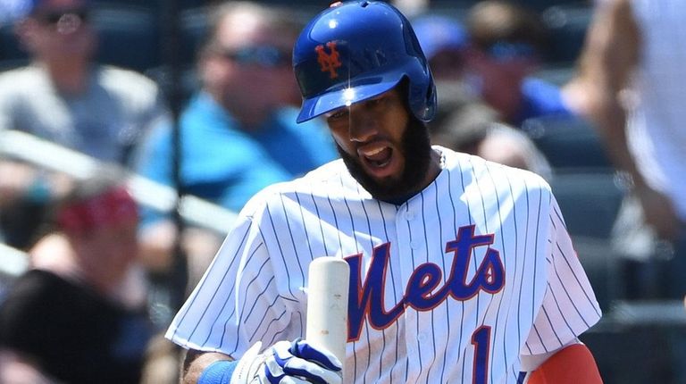 Mets shortstop Amed Rosario reacts after he strikes