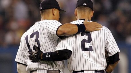 Yankees Alex Rodriguez and Derek Jeter wear the