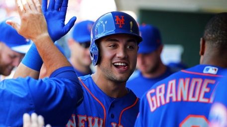 Michael Conforto of the Mets high-fives teammates after