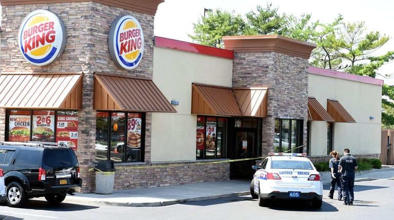 Suffolk County police investigate an armed robbery of