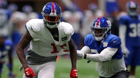 Giants cornerback Eli Apple grabs a handful of