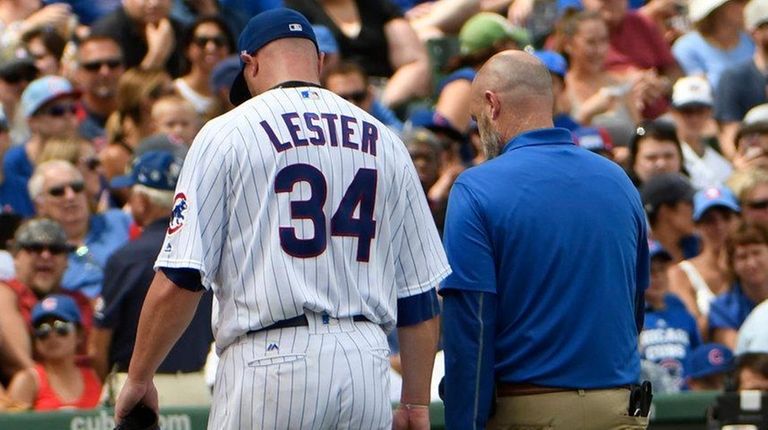 Cubs starting pitcher Jon Lester leaves the game during