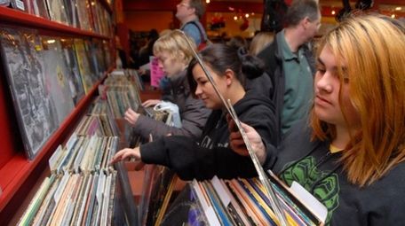 Customers sort through records at Looney Tunes in